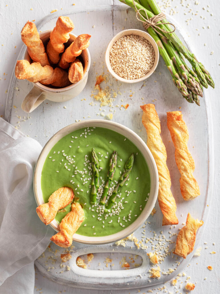 Cremige grüne Spargelsuppe mit Spinat, Sesam & knusprigen Blätterteig-Stangen
