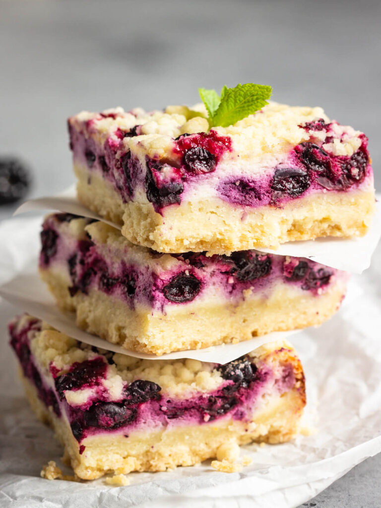Zitronen-Cheesecake-Schnitten mit schwarzen Johannisbeeren & Streuseln