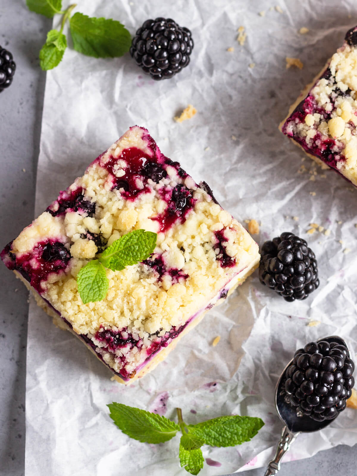 Zitronen-Cheesecake-Schnitten mit schwarzen Johannisbeeren & Streuseln