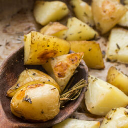 Ofenkartoffeln auf Holzlöffel mit Rosmarin