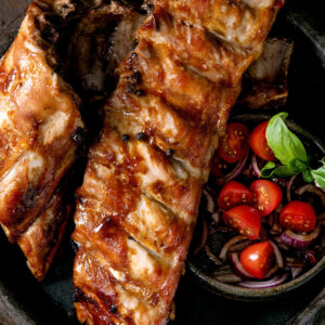 Spareribs aus dem Ofen mit dunkler BBQ-Glasur und Tomaten-Zwiebel-Salat