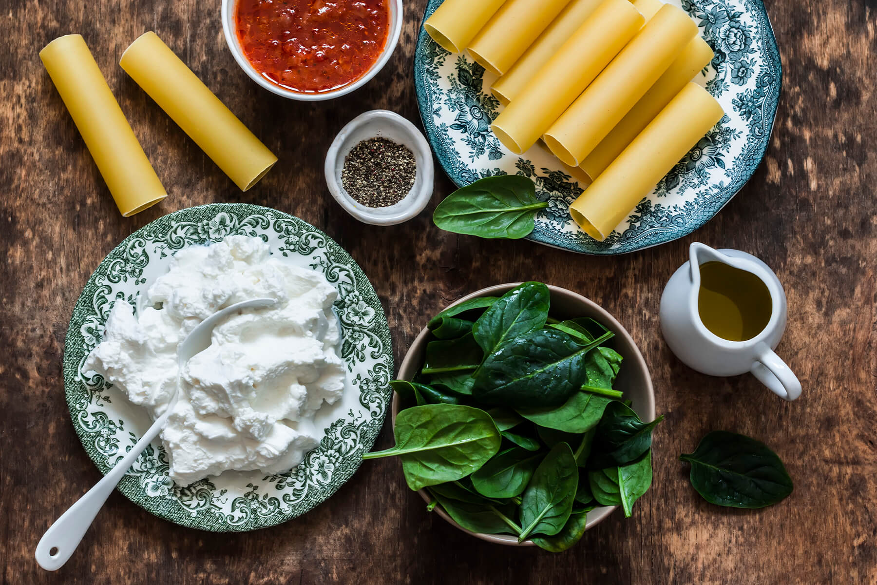 Zutaten für Cannelloni mit Spinat-Ricotta – rohe Nudelröhren, cremige Ricotta, frischer Blattspinat, rustikale Tomatensauce und Olivenöl