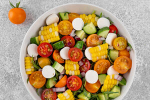 Mais-Salat mit Mozzarella und mehrfarbigen Cherrytomaten von oben