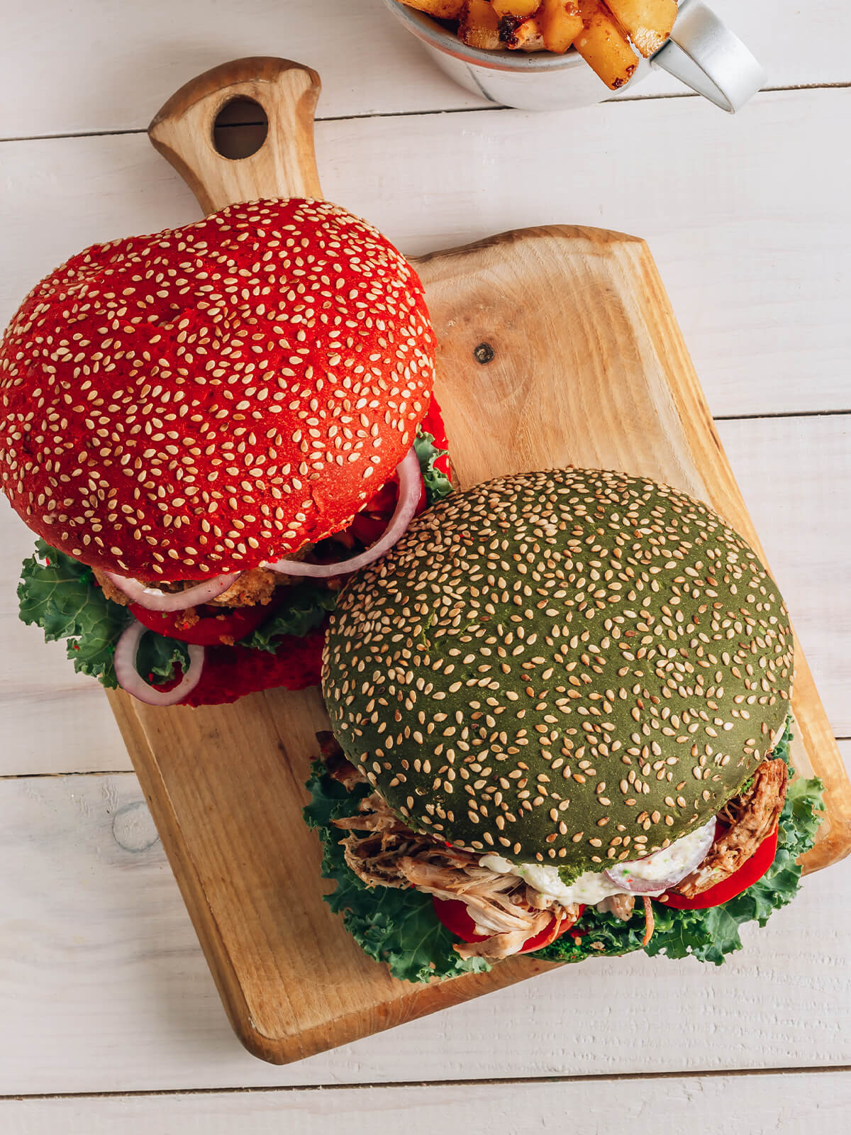 Roter und grüner Sesam-Burger mit Hähnchen von oben auf einem Holzbrett