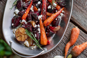 Angerichtete ofengeröstete Rote Bete mit Möhren, Feta und Rosmarin auf einer Platte von oben