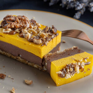 Vegane Kürbis-Schoko-Riegel mit Dattel-Nuss-Boden, Schokoladencreme und Kürbisschicht, garniert mit Walnüssen und Schokolade