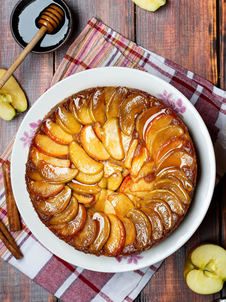 Gestürzter Apfelkuchen mit glänzendem Honig-Karamell und goldbraunen Apfelspalten, von oben fotografiert